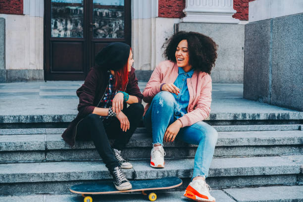 istock Young girls relaxing on urban steps with skateboard 2197458139