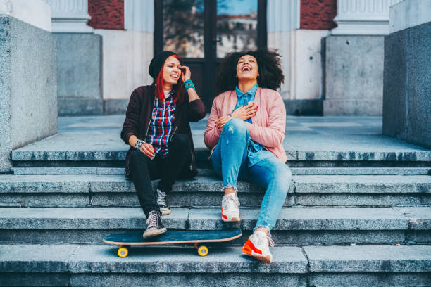 istock Young girls relaxing on urban steps with skateboard 2197458308