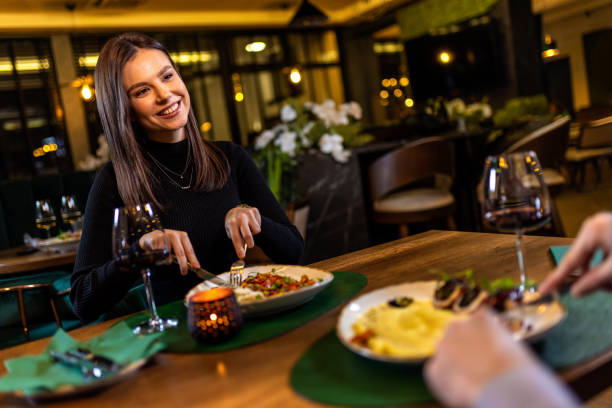 istock Happy girlfriend in a restaurant on a dinner date with her partner. 2197459959