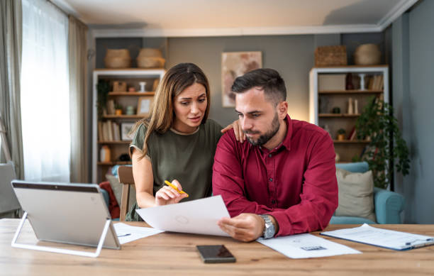 istock Worried young couple manages home finances 2197460204