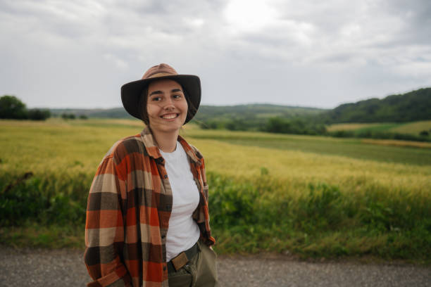 istock Smiling young woman on a cloudy day 2197460225