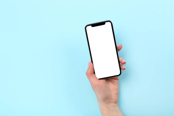 istock Smartphone in female hand on blue background 2197460254