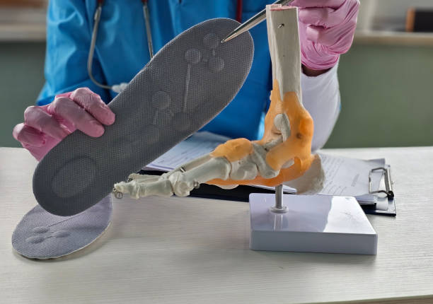 istock Doctor installing a custom orthopedic insole on a patient foot closeup 2197461061