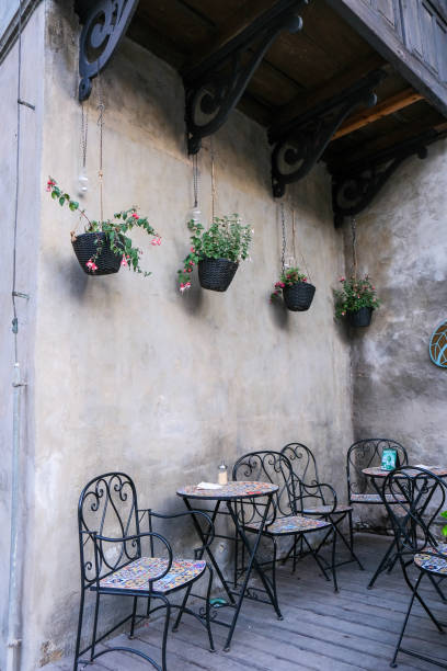 istock Cozy Outdoor Seating with Hanging Plants 2197462706