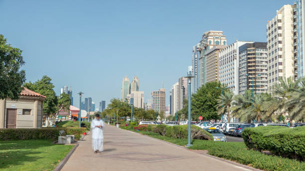 istock Corniche boulevard beach park along the coastline in Abu Dhabi timelapse with skyscrapers on background. 2197465647