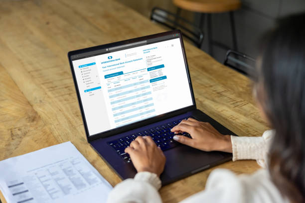 istock Close-up on a woman at home checking a bank statement online 2197466792