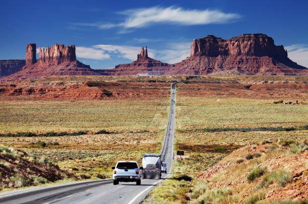 Car queue in front of the park entrance. The Arches. USA. The asphalt highway passes through the most interesting majestic compositions created by wind and water.