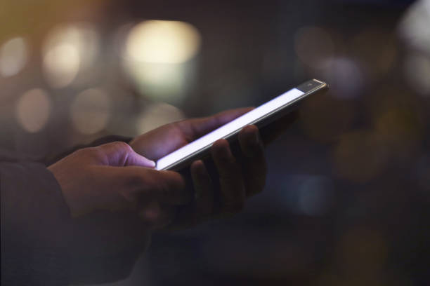 istock Man using mobile phone at night on street 2197467261