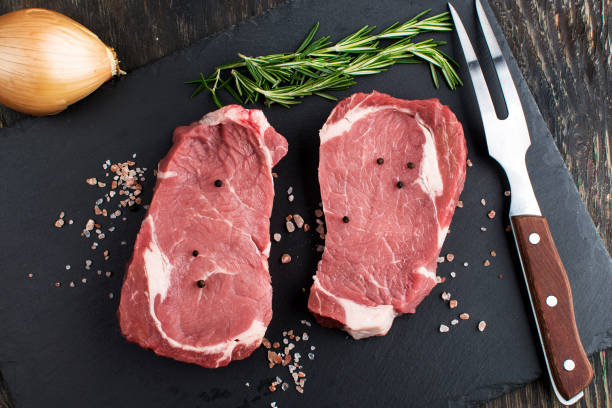 istock two raw steaks on a cutting board. view from above 2197467402
