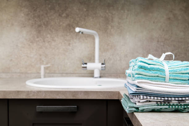 istock stack of colorful kitchen towels on the kitchen table next to the sink. 2197467483