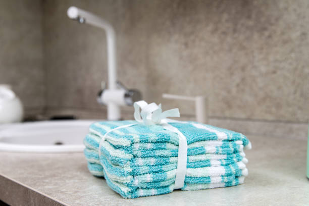 istock stack of colorful kitchen towels on the kitchen table next to the sink. 2197467485