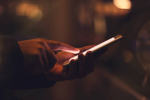 istock Man using mobile phone at night on street 2197467516