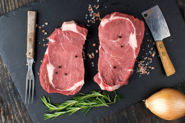 istock two raw steaks on a cutting board. view from above 2197468059