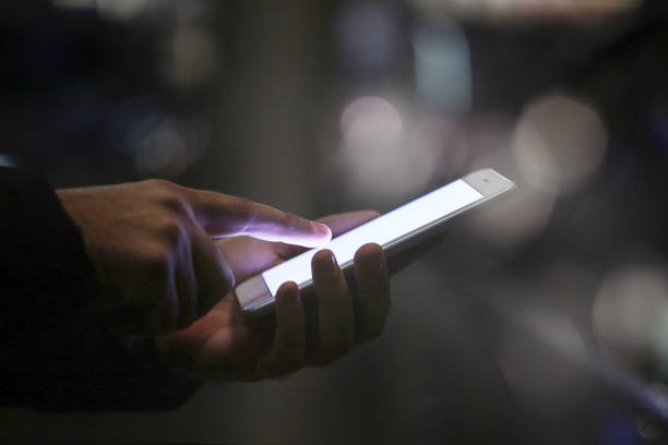 istock Man using mobile phone at night on street 2197468181