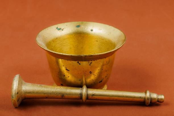 Old Bronze mortar and pestle on wooden background