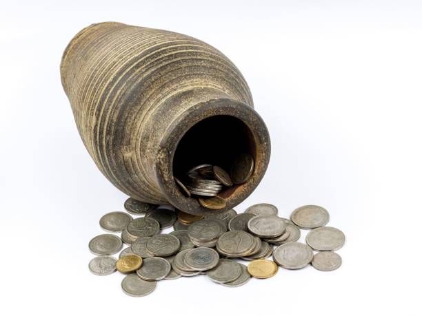 istock Antique clay pot with vintage coins. 2197469760