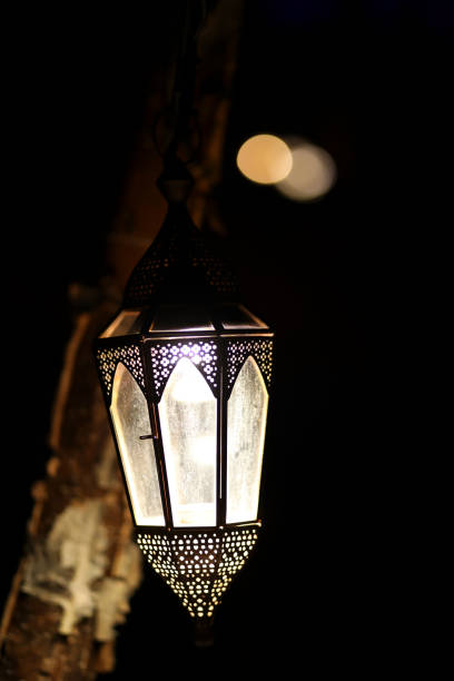 Ramadan decoration illuminated arabic lantern against blue background