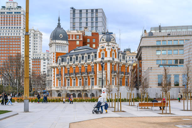 Madrid, Spain - January 5, 2025: People on a town square by the Royal Asturian Mines Company Building (in the center)