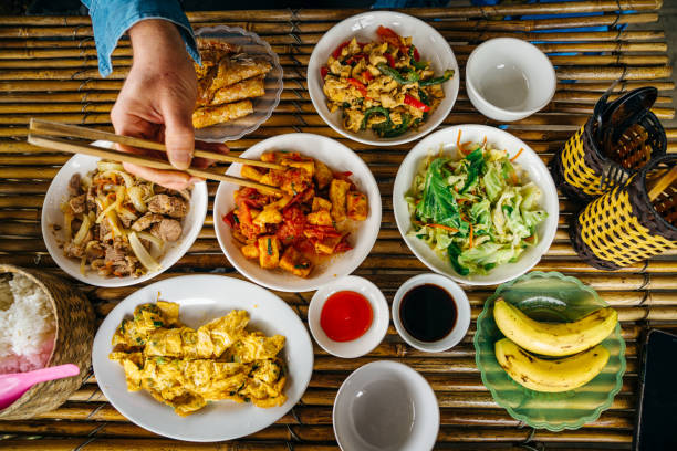 istock Traditional Vietnamese Meal Spread with Nem Lop and Various Dishes on a Bamboo Table 2197471764