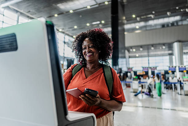 istock Senior woman doing check-in on a airport 2197474293