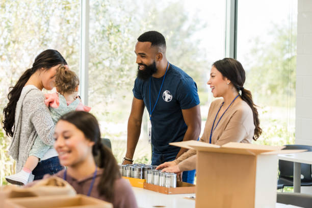 istock Volunteers Sorting Canned Goods at Community Outreach Event 2197479715