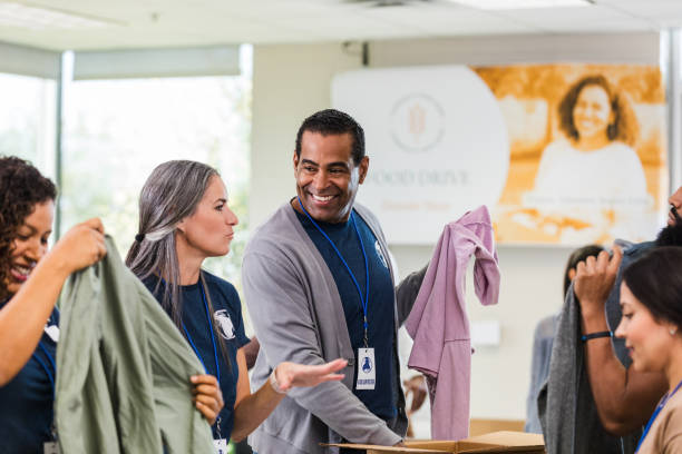 istock Diverse Group of Volunteers Sorting Donations at a Charity 2197479738