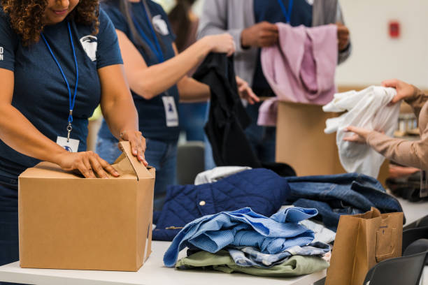 istock Volunteers Sorting Clothing Donations at a Charity 2197479752