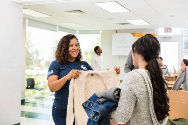 istock Happy Volunteer Donating Clothes at Community Center 2197479756