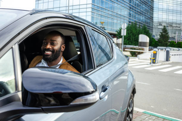 istock Smiling man securing seatbelt while seated in a modern car 2197479891