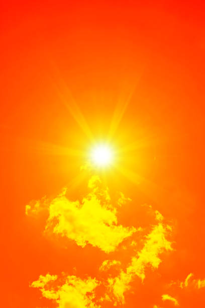 istock Bright sun with beautiful beams in the sky with clouds (toned in red) 2197481485
