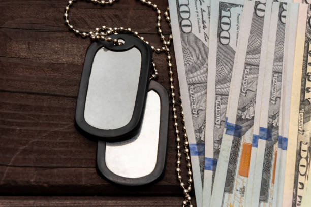 istock The serviceman's token among U.S. banknotes reflects the connection between the military and finance. 2197482134