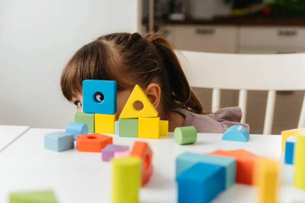istock Young Girl Playing and Learning with Colorful Wooden Blocks 2197482257