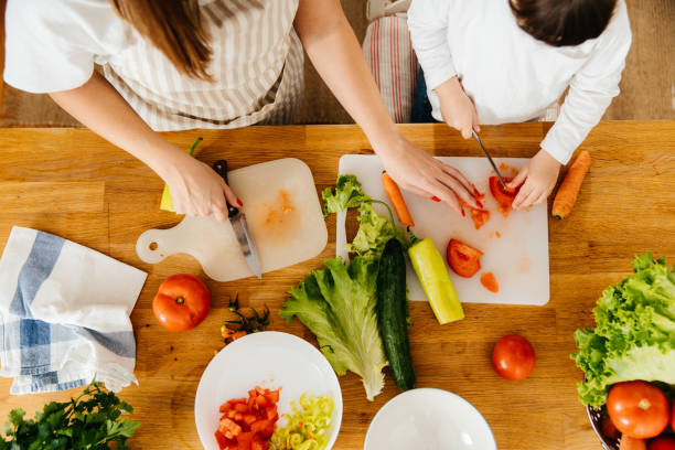 istock Mother and Daughter Preparing Fresh Vegetables Together in the Kitchen 2197485805