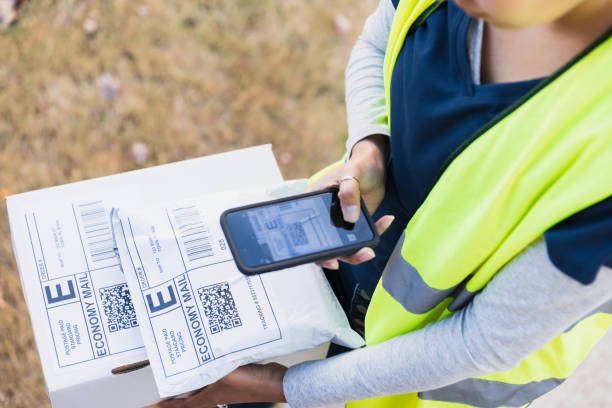 istock Delivery Person Scanning Package with Smartphone 2197485813
