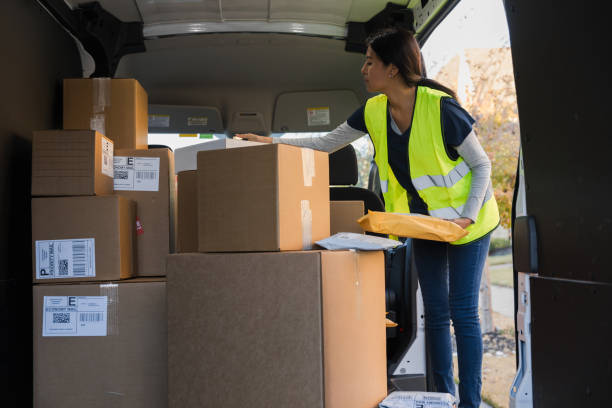 istock Delivery woman organizing packages in van 2197485824