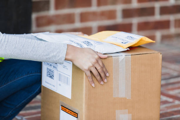 istock Woman placing packages on a cardboard box for delivery 2197485839