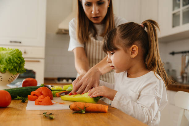 istock Mother and Daughter Preparing Fresh Vegetables Together in the Kitchen 2197485915