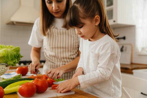 istock Mother and Daughter Preparing Fresh Vegetables Together in the Kitchen 2197485946