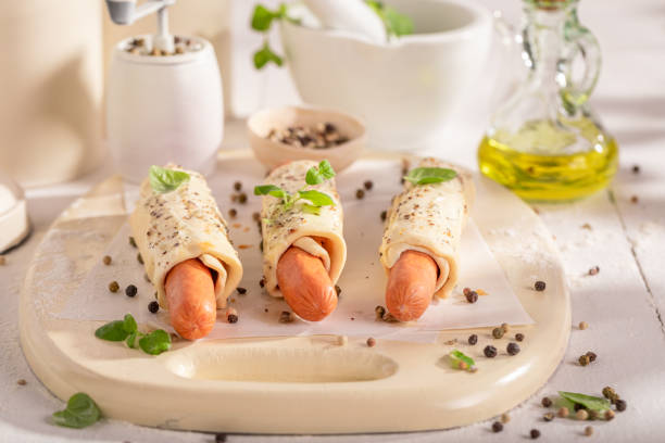 Homemade hot dogs prepared in bright kitchen. Spicy hot dog made of puff pastry and pepper.