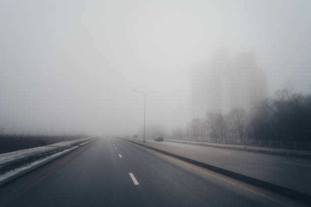 istock Foggy misty road at winter day 2197487196