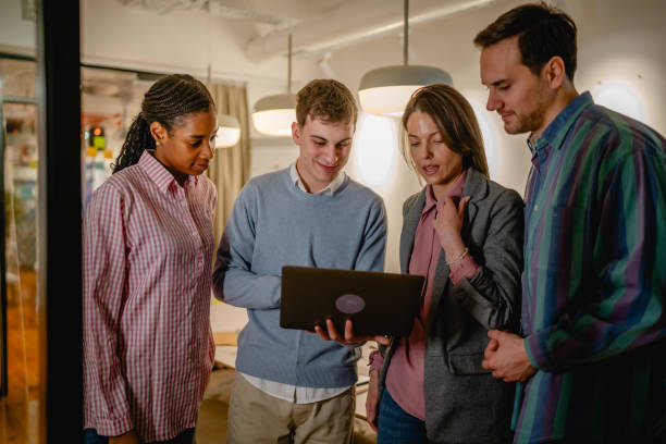 istock diverse group businesspeople stand and use laptop in the office 2197489825
