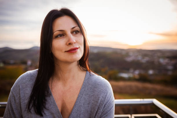 istock Contemplative Woman Enjoying Serene Sunset in Countryside Setting 2197489895