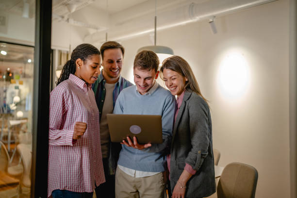 istock diverse group businesspeople stand and use laptop in the office 2197489903