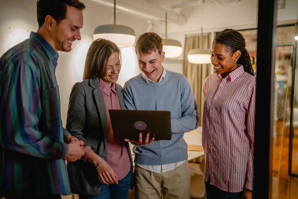 istock diverse group businesspeople stand and use laptop in the office 2197490068