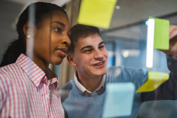 istock Diverse male and female colleague brainstorming with sticky notes 2197490146