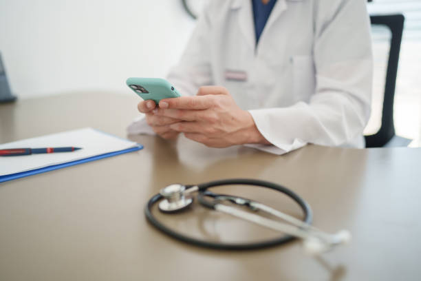 istock Close up to doctor's hand using mobile phone at the clinic. 2197491507