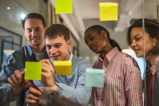 istock Diverse group of businesspeople brainstorming with sticky notes 2197491791