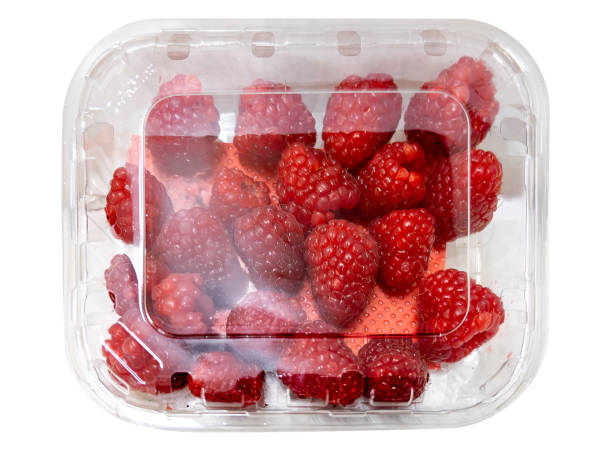 istock Raspberries in clear plastic box for sale 2197495025