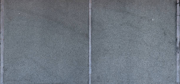 istock Weathered concrete wall background with rough texture, cracks, vertical lines and gray color 2197497473