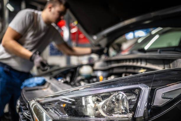 istock Male Mechanic Repairing Car Engine in Workshop 2197500413